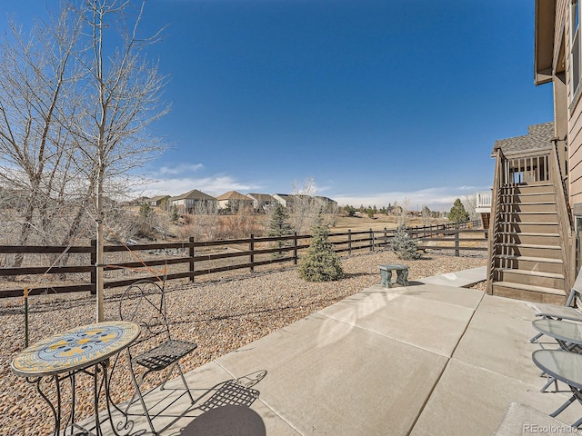 view of patio with stairway and a fenced backyard