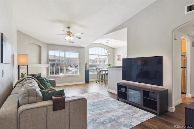18669 Stroh Rd Unit 10208, Parker, CO 80134 - living area with arched walkways, a ceiling fan, wood finished floors, vaulted ceiling, and baseboards