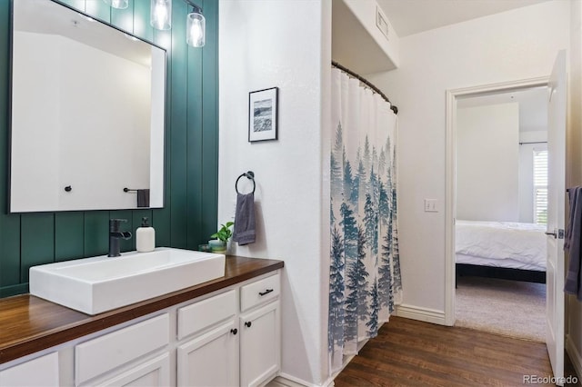 18669 Stroh Rd Unit 10208, Parker, CO 80134 - bathroom featuring vanity, wood finished floors, ensuite bath, baseboards, and curtained shower