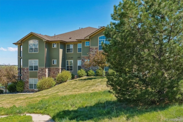 18669 Stroh Rd Unit 10208, Parker, CO 80134 - rear view of property with stone siding and a yard