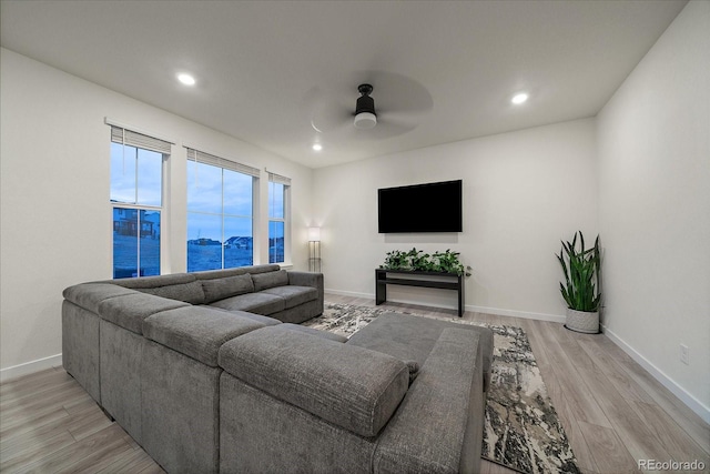 living room featuring ceiling fan and light wood-type flooring