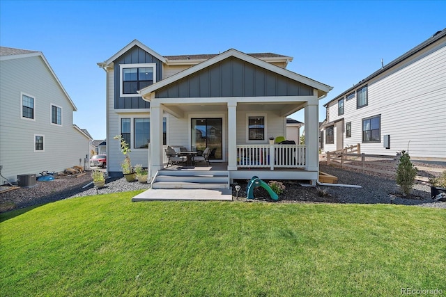 back of house featuring a yard and covered porch