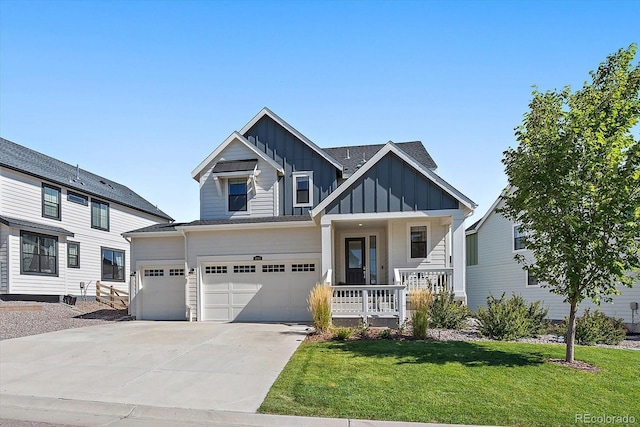 view of front of home featuring a porch, a garage, and a front yard