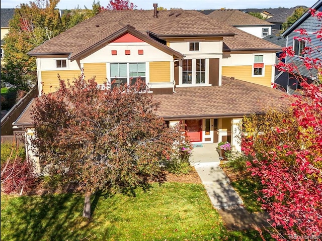 view of front of property featuring french doors and a front lawn