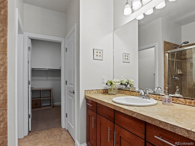 bathroom with vanity, tile patterned floors, and a shower with door