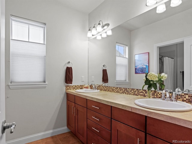 bathroom with vanity, backsplash, and tile patterned flooring