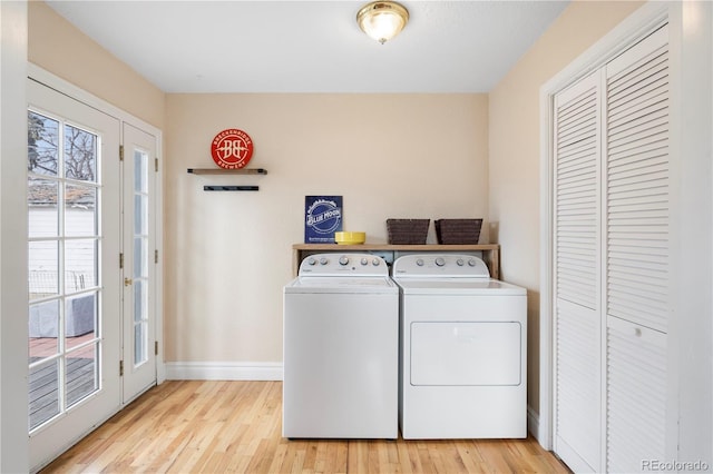 laundry area featuring washer and dryer and light wood-type flooring