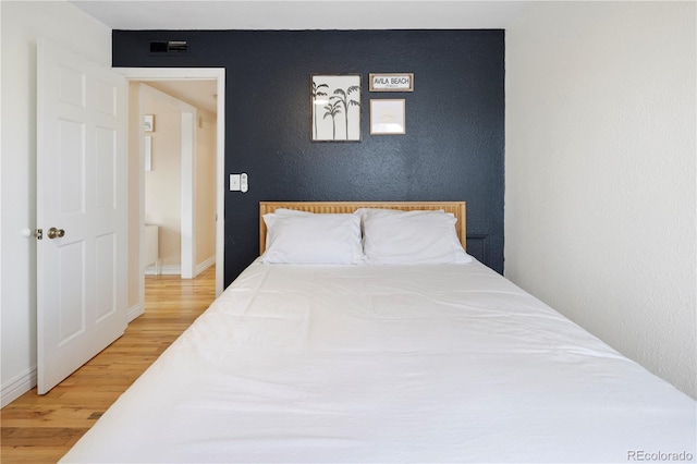 bedroom with hardwood / wood-style floors