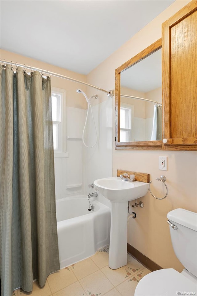 full bathroom featuring tile patterned floors, a healthy amount of sunlight, toilet, and shower / bathtub combination with curtain