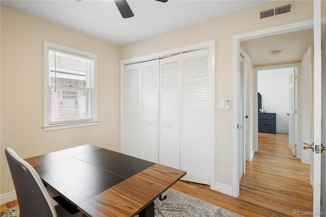 office area with light wood-type flooring and ceiling fan