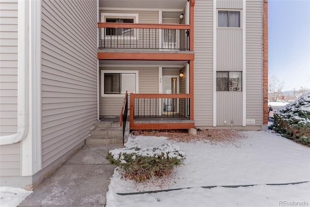 view of snow covered property entrance