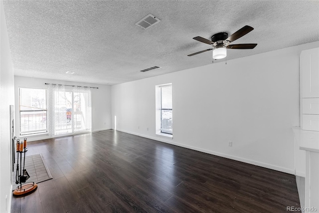 unfurnished room featuring ceiling fan, dark hardwood / wood-style flooring, and a textured ceiling