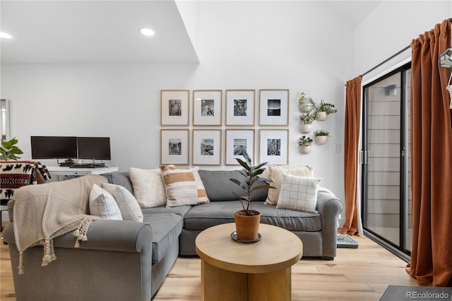 living room with light wood-style flooring and recessed lighting