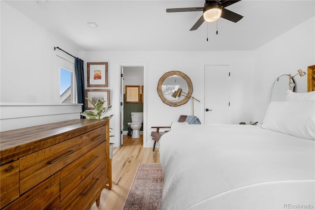 bedroom featuring ensuite bath, light wood-type flooring, and ceiling fan