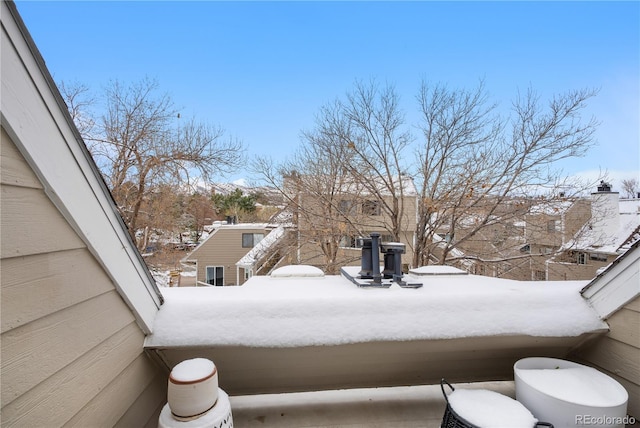 yard layered in snow with a balcony