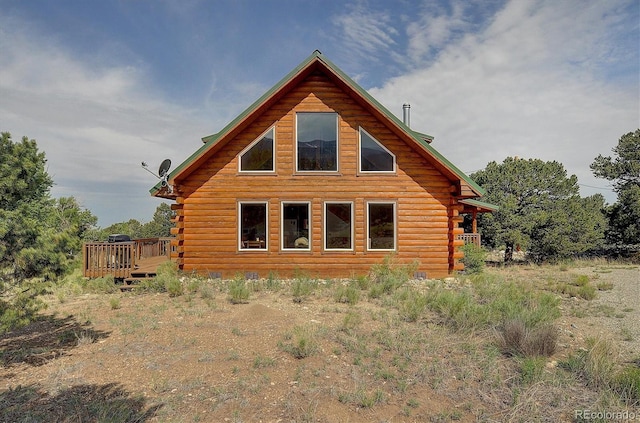 view of home's exterior featuring log siding and a wooden deck