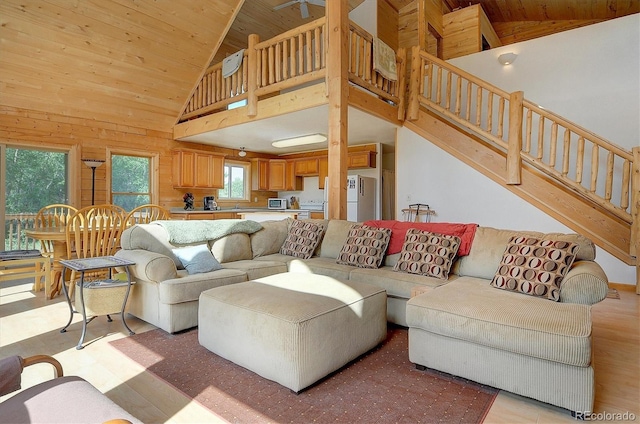 living room with stairway, wooden ceiling, high vaulted ceiling, and light wood-type flooring