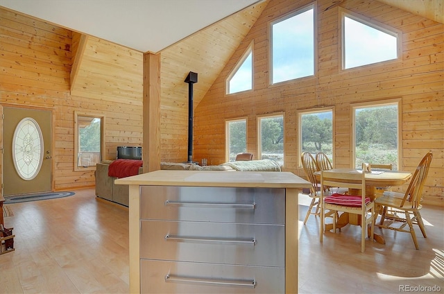 kitchen with wooden walls, open floor plan, and a wealth of natural light