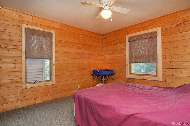 carpeted bedroom with wood walls