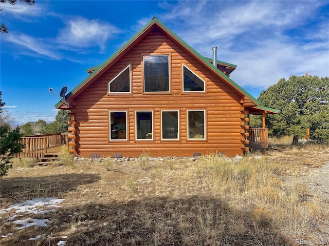 view of home's exterior featuring crawl space, log exterior, and a deck