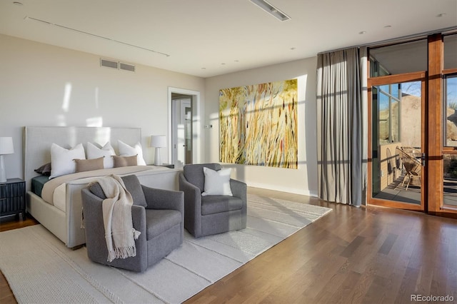 bedroom with access to exterior and wood-type flooring