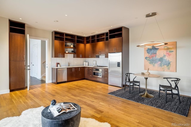 kitchen featuring tasteful backsplash, appliances with stainless steel finishes, and light hardwood / wood-style floors