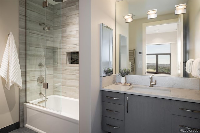 bathroom with vanity and combined bath / shower with glass door