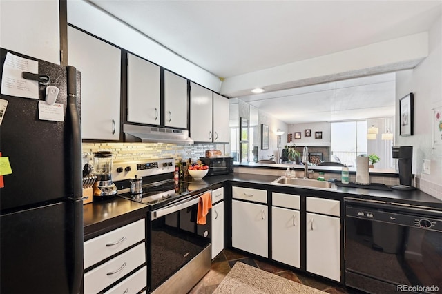 805 29th St Unit 308, Boulder, CO 80303 - kitchen with black appliances, under cabinet range hood, dark countertops, a sink, and decorative backsplash