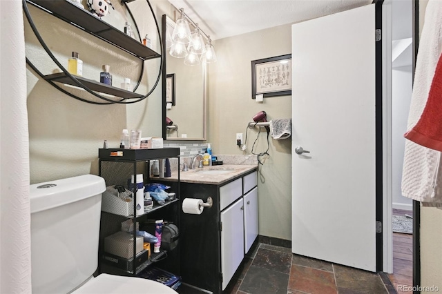 805 29th St Unit 308, Boulder, CO 80303 - half bathroom with toilet, stone tile floors, vanity, and baseboards