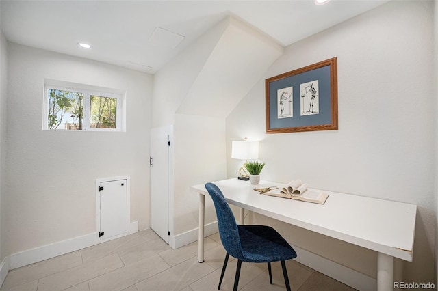 home office with built in desk, light tile patterned floors, and vaulted ceiling