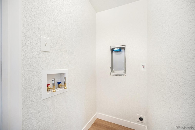 washroom with hookup for a washing machine, hardwood / wood-style flooring, and electric dryer hookup