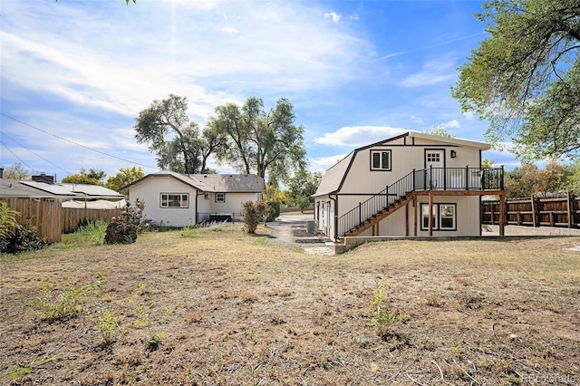 back of property with a wooden deck