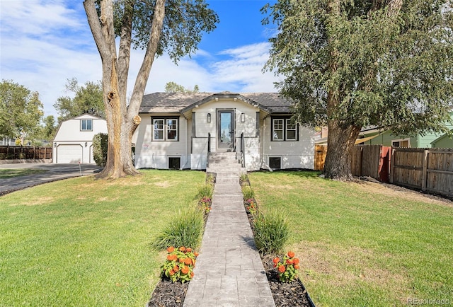 view of front of home with a front lawn and a garage