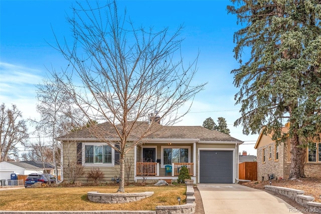 view of front of house with a garage, covered porch, and a front lawn