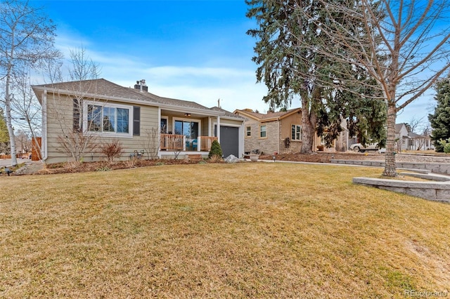 view of front of house featuring a porch, a garage, and a front lawn