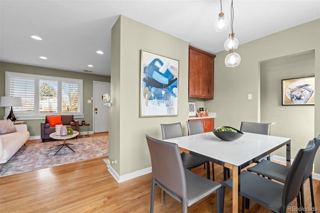 dining space featuring light wood-type flooring