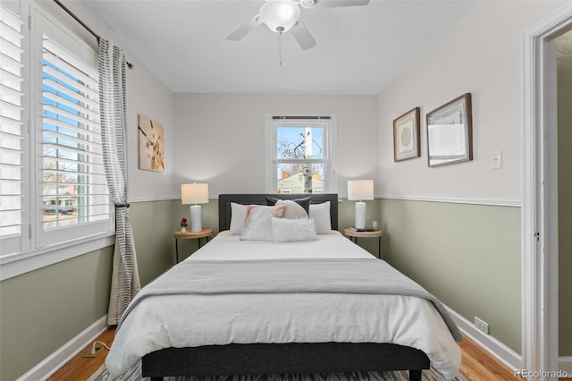 bedroom with ceiling fan and hardwood / wood-style floors