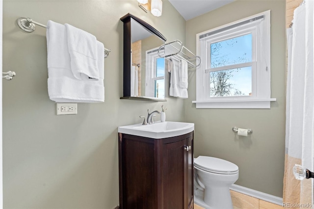 bathroom with vanity, toilet, and tile patterned flooring