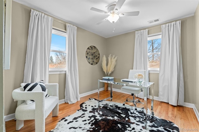 home office featuring hardwood / wood-style floors, a wealth of natural light, and ceiling fan