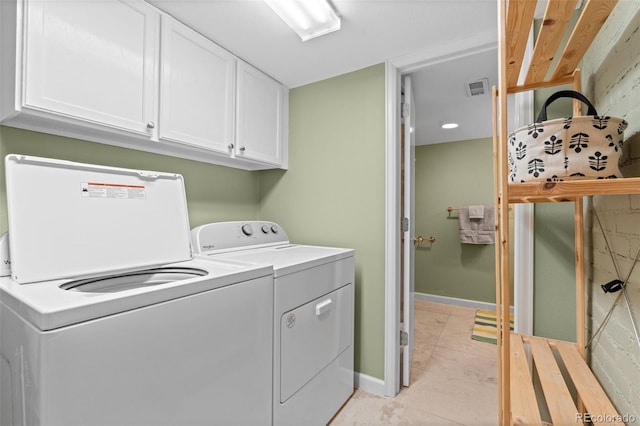 washroom featuring cabinets, separate washer and dryer, and light tile patterned floors