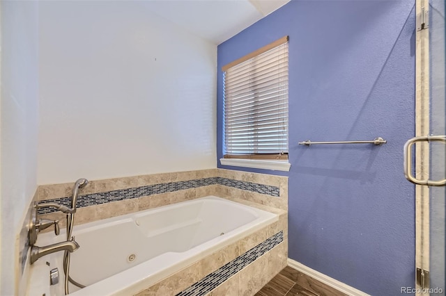 bathroom featuring a relaxing tiled tub