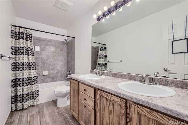 full bathroom featuring shower / bath combination with curtain, vanity, hardwood / wood-style flooring, and toilet