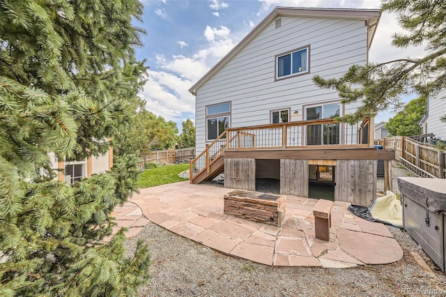 rear view of property featuring a deck and a patio