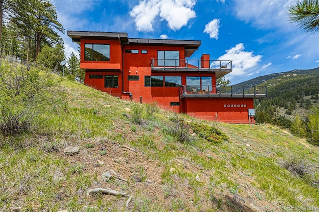 5896 Peregrine Trl, Golden, CO 80403 - back of property featuring a balcony and a mountain view