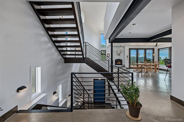 5896 Peregrine Trl, Golden, CO 80403 - stairway featuring healthy amount of natural light, finished concrete floors, and baseboards