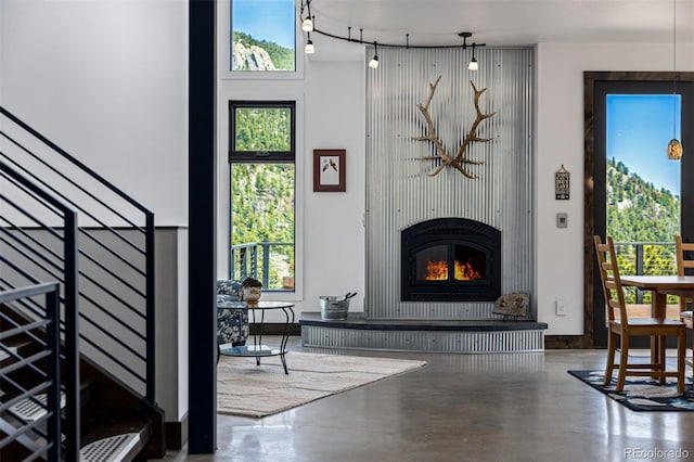 5896 Peregrine Trl, Golden, CO 80403 - living room featuring concrete flooring, a fireplace, and plenty of natural light