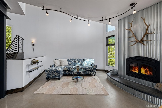 5896 Peregrine Trl, Golden, CO 80403 - living room with finished concrete floors, baseboards, and rail lighting