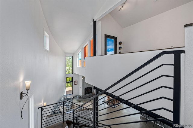 5896 Peregrine Trl, Golden, CO 80403 - stairway with a fireplace and high vaulted ceiling