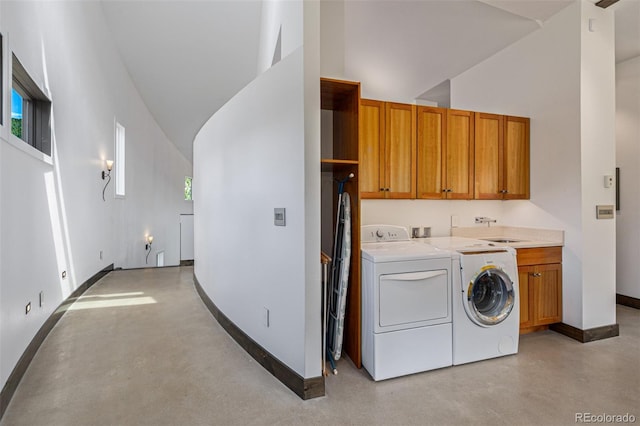 5896 Peregrine Trl, Golden, CO 80403 - laundry room featuring cabinet space, separate washer and dryer, a towering ceiling, and baseboards