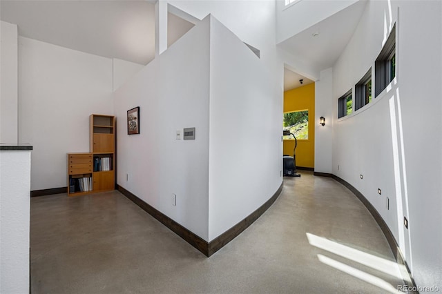 5896 Peregrine Trl, Golden, CO 80403 - hall with finished concrete floors, a towering ceiling, and baseboards